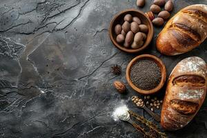 Rustic still life of assorted breads grains and spices on a dark stone table photo