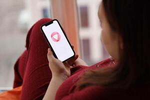 KYIV, UKRAINE - FEBRUARY 23, 2024 Open logo of famous dating website or app on iPhone display photo