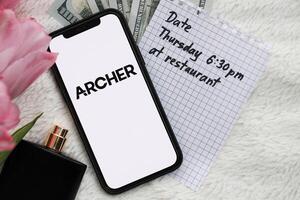 KYIV, UKRAINE - FEBRUARY 23, 2024 Archer logo of famous dating website or app on iPhone display photo