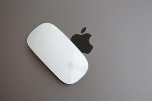 KYIV, UKRAINE - NOVEMBER 27, 2023 Apple Magic Mouse 3rd generation lies with grey MacBook 2021 photo