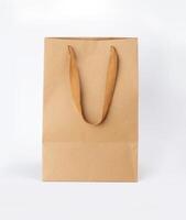 Folded paper bag with handle isolated on white background photo