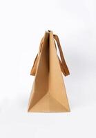Folded paper bag with handle isolated on white background photo