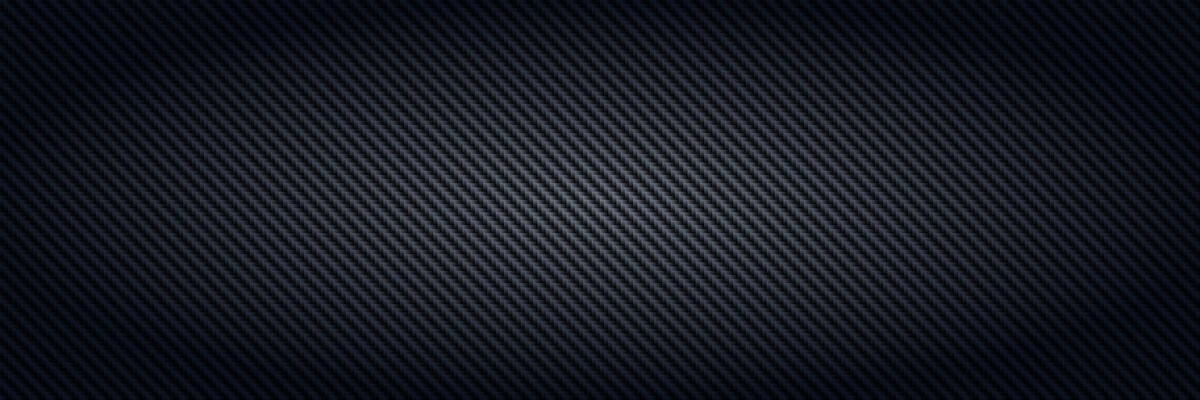 Carbon fiber. Black interlaced fibers texture, light material for sport car tuning and strong aramid structure dark panoramic background