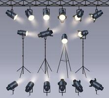 Realistic spotlights. Lamp on tripod stand, photo studio or stage light equipment. Spotlight with light beam glow effect set vector