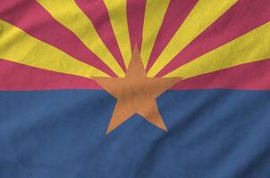 Arizona US state flag depicted on folded wavy fabric of old cloth photo