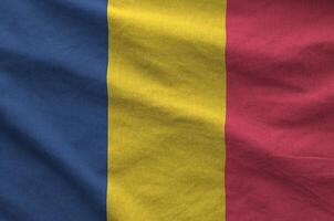 Chad flag depicted on folded wavy fabric of old cloth photo