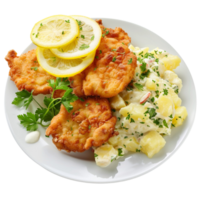 German schnitzel with lemon slices and parsley, accompanied by potato salad on a transparent background png