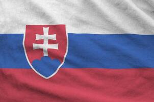Slovakia flag depicted on folded wavy fabric of old cloth photo