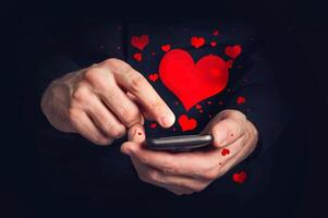 Man typing love text messages on a smartphone for Valentine's day photo