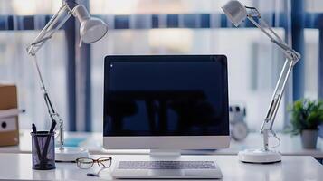 Laptop Computer, notebook, and eyeglasses sitting on a desk in a large open plan office space after working hours photo