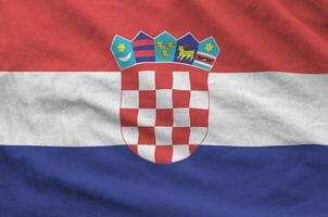 Croatia flag depicted on folded wavy fabric of old cloth photo