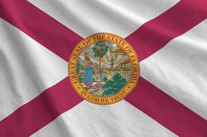 Florida US state flag depicted on folded wavy fabric of old cloth photo
