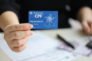 KYIV, UKRAINE - OCTOBER 31, 2023 Blue CPF card document template. The document guarantees authenticity and integrity in electronic communication between people in Brazil photo