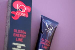 KYIV, UKRAINE - OCTOBER 31, 2023 Tube of IQ Code Gloss and Energy Line colorizer cream for hair photo