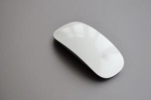 KYIV, UKRAINE - NOVEMBER 27, 2023 Apple Magic Mouse 3rd generation lies with grey MacBook 2021 photo