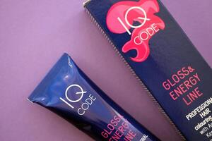 KYIV, UKRAINE - OCTOBER 31, 2023 Tube of IQ Code Gloss and Energy Line colorizer cream for hair photo
