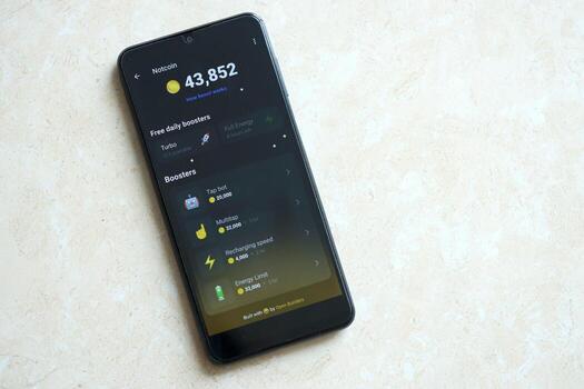 KYIV, UKRAINE - APRIL 20, 2024 Notcoin telegram bot on smartphone screen. Notcoin is a viral Telegram based crypto game for earn tokens by managing virtual crypto exchange photo