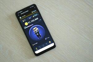 KYIV, UKRAINE - APRIL 20, 2024 Hamster Kombat telegram bot on smartphone screen. Hamster Kombat is a viral Telegram crypto game for earn HMSTR tokens by managing virtual crypto exchange photo