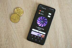 KYIV, UKRAINE - APRIL 20, 2024 Tronix App telegram bot on smartphone screen. Tronix App is a viral Telegram based crypto game for earn TRX tokens by managing virtual crypto exchange photo