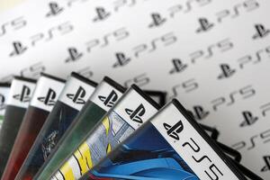 KYIV, UKRAINE - JUNE 26, 2024 Stack of games for Sony Playstation 5 and 4 console. Many disc boxes of popular games photo