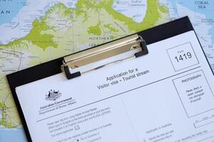 KYIV, UKRAINE - JULY 10, 2024 Australian application for a visitor visa Form 1419 to travel to Australia on table photo