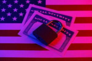 Padlock and social security card on United States flag. Identity theft and identity protection concept photo