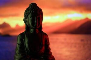 Buddha Purnima and Vesak day concept, Buddha statue with low key light against beautiful and colorful background. Meditation photo