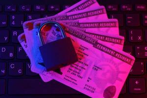 Permanent resident green card for US DV-lottery with small padlock on computer keyboard photo