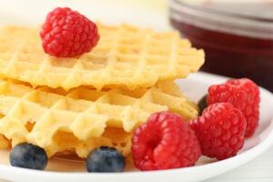 Belgian waffles with raspberry jam. Belgian waffles with berries photo