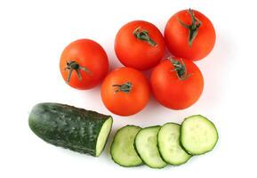 Tomatoes and cucumbers isolate top view photo
