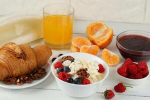 Breakfast with cheese and croissant. breakfast table with cheese, berries and croissant. Top view of breakfast photo