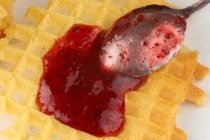 Belgian waffles with raspberry jam. Belgian waffles with berries photo