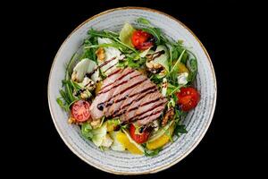 Duck Salad with Teriyaki Sauce on Black Background for Food Delivery Menu photo