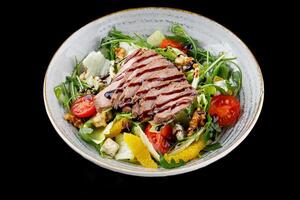 Duck Salad with Teriyaki Sauce on Black Background for Food Delivery Menu photo