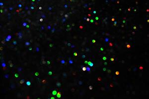 Abstract black background with bokeh of different colors. photo