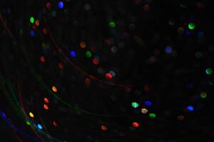 Abstract black background with bokeh of different colors. photo