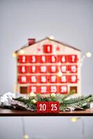 Christmas Advent calendar in the shape of a house with boxes making up the number 2025. photo