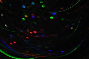 Abstract black background with bokeh of different colors. photo