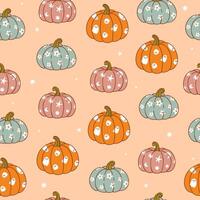 Seamless pattern of patterned pumpkins on a peach background. graphics. vector