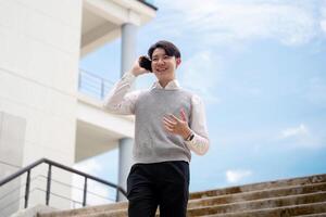 Young Professional Talking on Phone Outside Modern Office Building on a Sunny Day photo