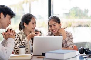 Group of Diverse Student Collaboration on a Project with a Laptop in a Modern Study Space photo