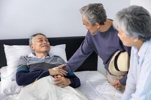 Senior fatal dying male patient with oxygen mask is getting consoling support from his friend and family while suffering from final stage cancer at home with palliative medical treatment concept photo