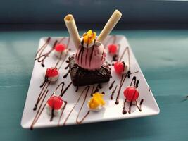 a dessert with chocolate and ice cream on a plate photo