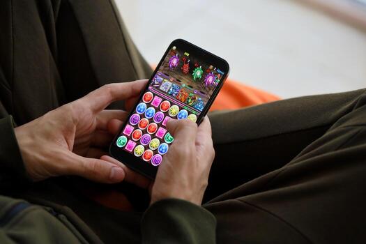 Puzzle and dragons mobile iOS game on iPhone 15 smartphone screen in male hands during mobile gameplay photo