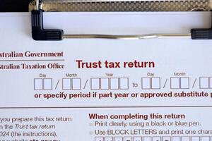 KYIV, UKRAINE - JULY 10, 2024 Australian Trust Tax Return blank form lies on table of Australian Government taxation office photo
