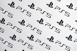 KYIV, UKRAINE - JUNE 26, 2024 Sony Playstation 5 console logo repeating many times on white paper background banner photo
