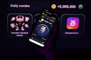KYIV, UKRAINE - APRIL 20, 2024 Hamster Kombat telegram bot on smartphone screen. Hamster Kombat is a viral Telegram-based crypto game for earn HMSTR tokens by managing virtual crypto exchange photo