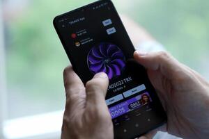 KYIV, UKRAINE - APRIL 20, 2024 Tronix App telegram bot on smartphone screen. Tronix App is a viral Telegram based crypto game for earn TRX tokens by managing virtual crypto exchange photo