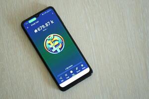 KYIV, UKRAINE - APRIL 20, 2024 EVAB TAP telegram bot on smartphone screen. EVAB TAP is a viral Telegram based crypto game for earn tokens by managing virtual crypto exchange photo