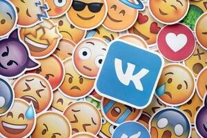 KYIV, UKRAINE - APRIL 20, 2024 VK logo and large set of stickers with Emoji yellow faces. Emoji is a pictogram or smiley embedded in text and used in electronic messages photo